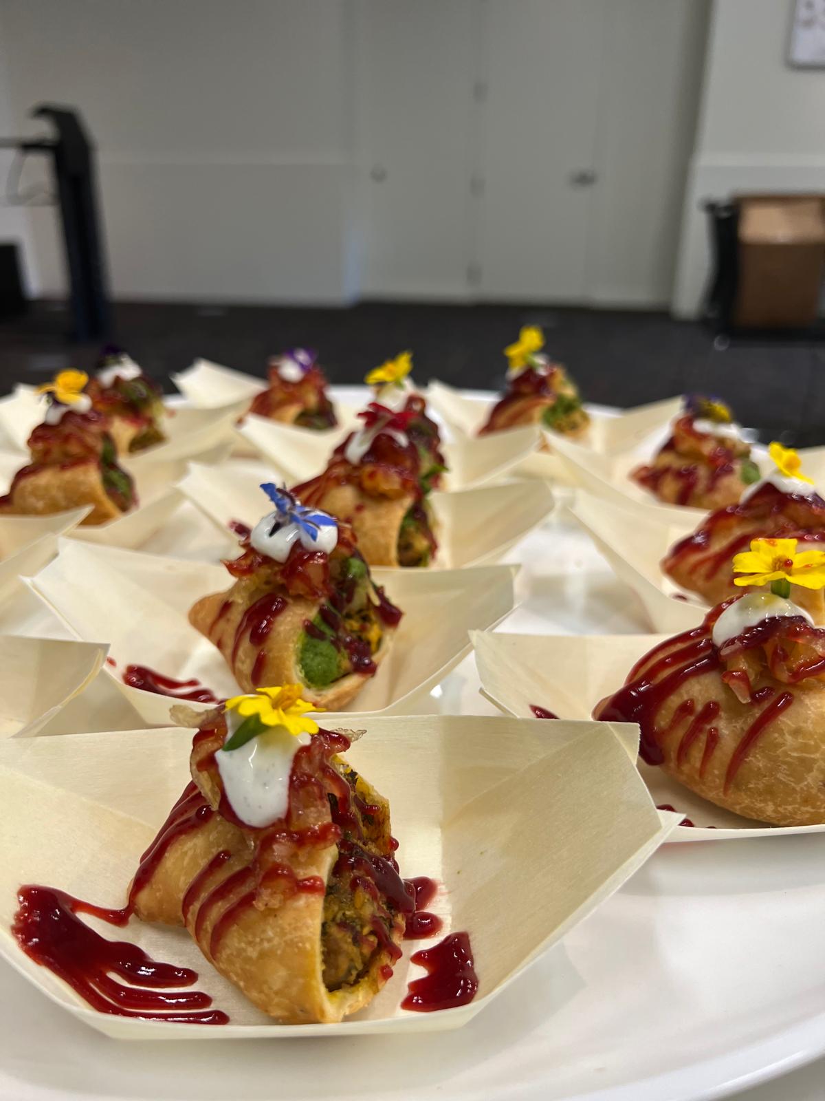 Plated Global Spice Kitchens catering appetizers with tamarind and mint chutney